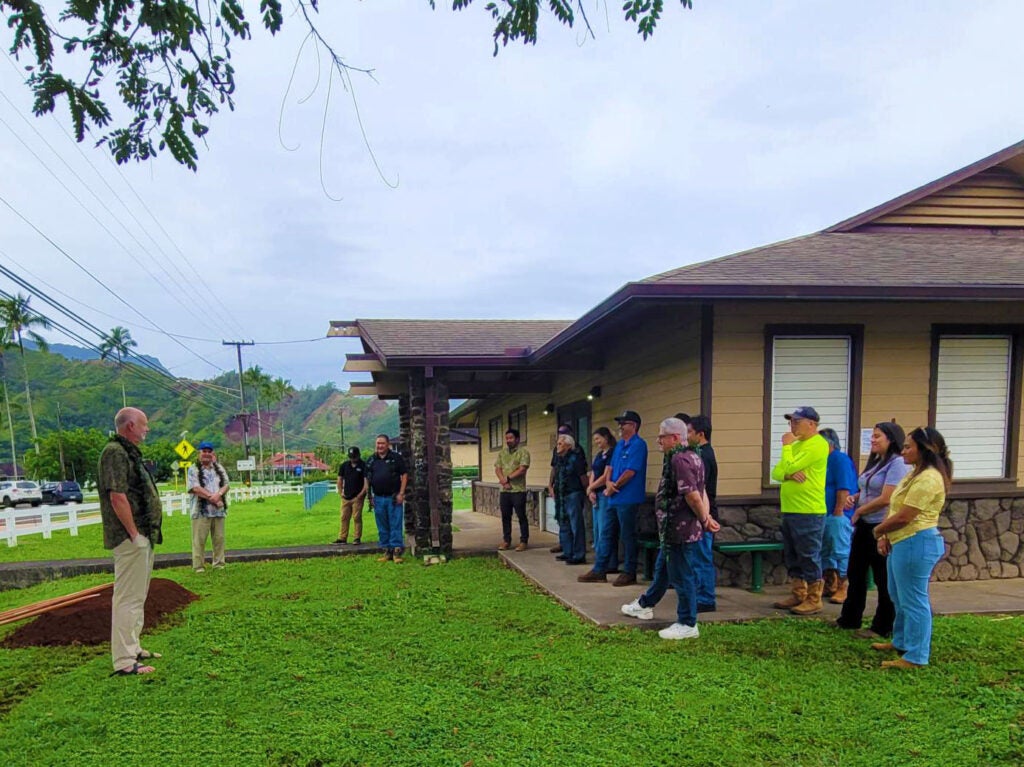 Reverend Dr. Mark Poppen (far left) speaks to attendees about the sacred value of water as a natural resource and its importance to the community.